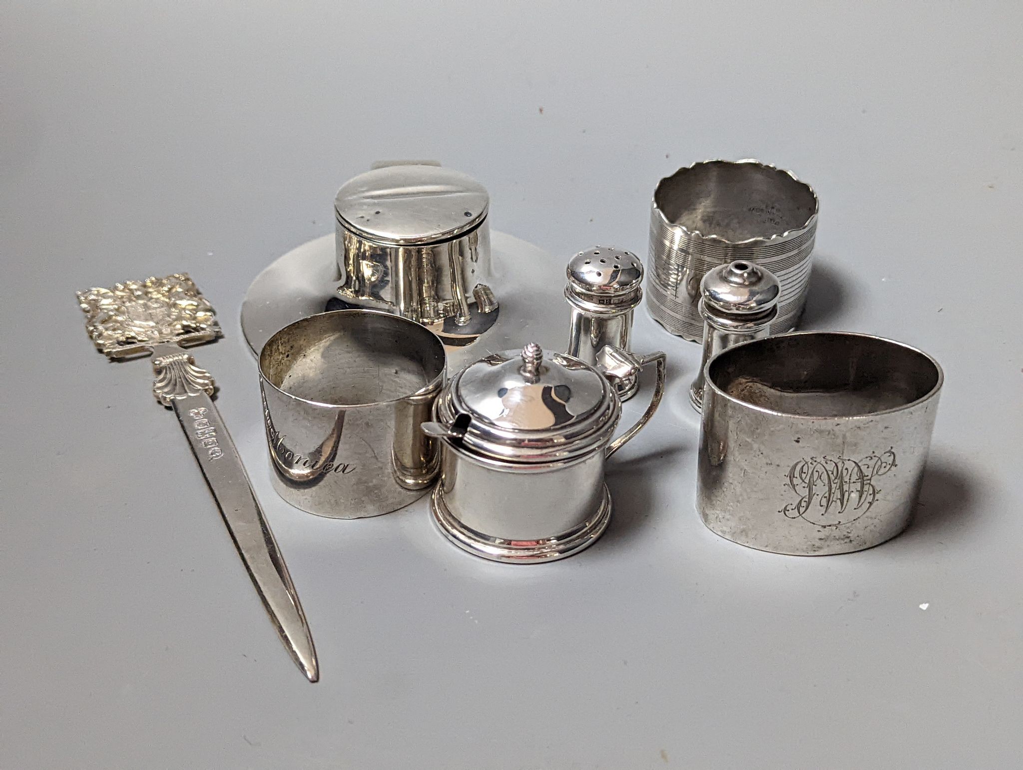 A modern Queens' Silver Jubilee commemorative silver paper knife, 16.9cm, London, 1977, a silver inkwell, three silver napkin rings and three silver condiments.